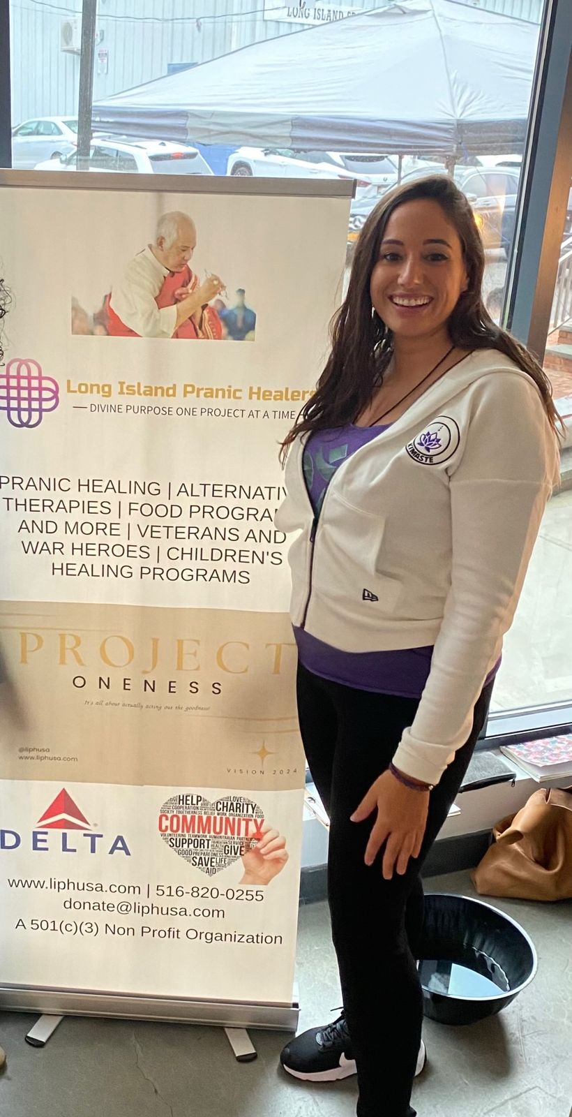 LIPH representative beside the Project Oneness banner
