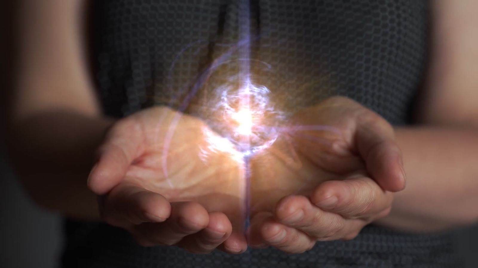 Hands holding glowing healing energy